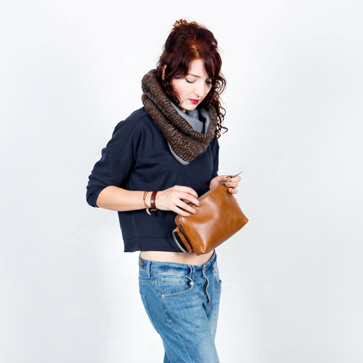 woman_full_size_standing_holding_shiny_brown_clutch