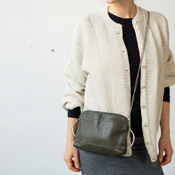 woman_wearing_a_cross-body_green_clutch